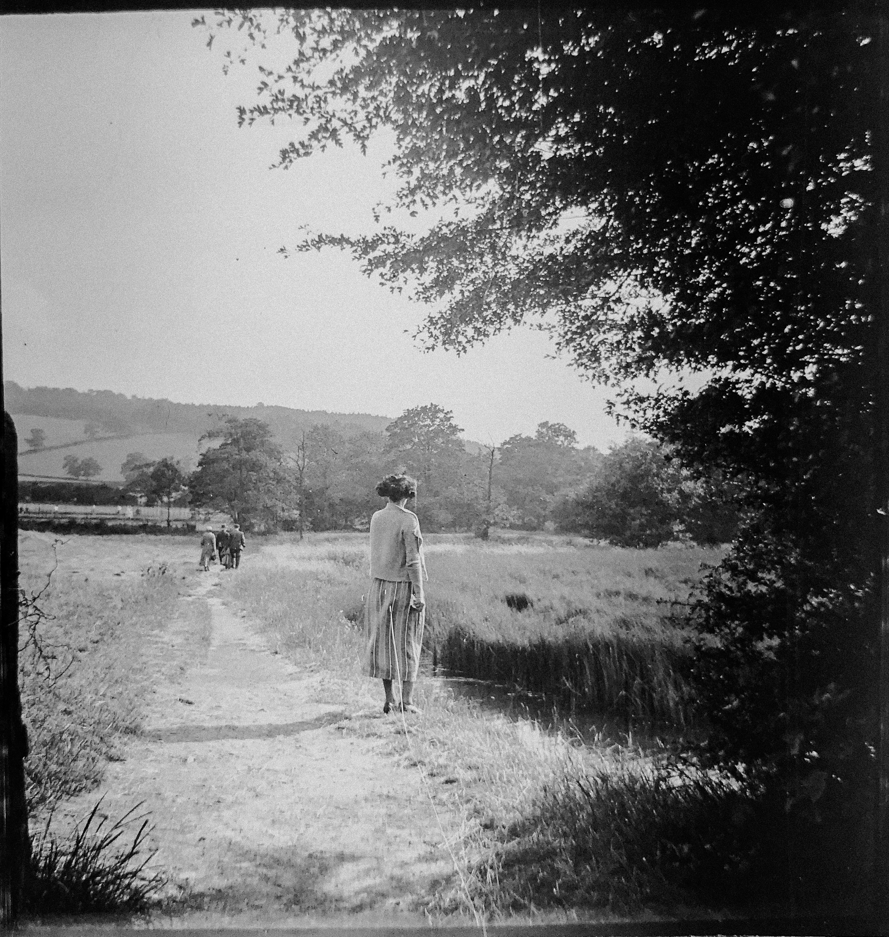 women in a field gray-scale photography