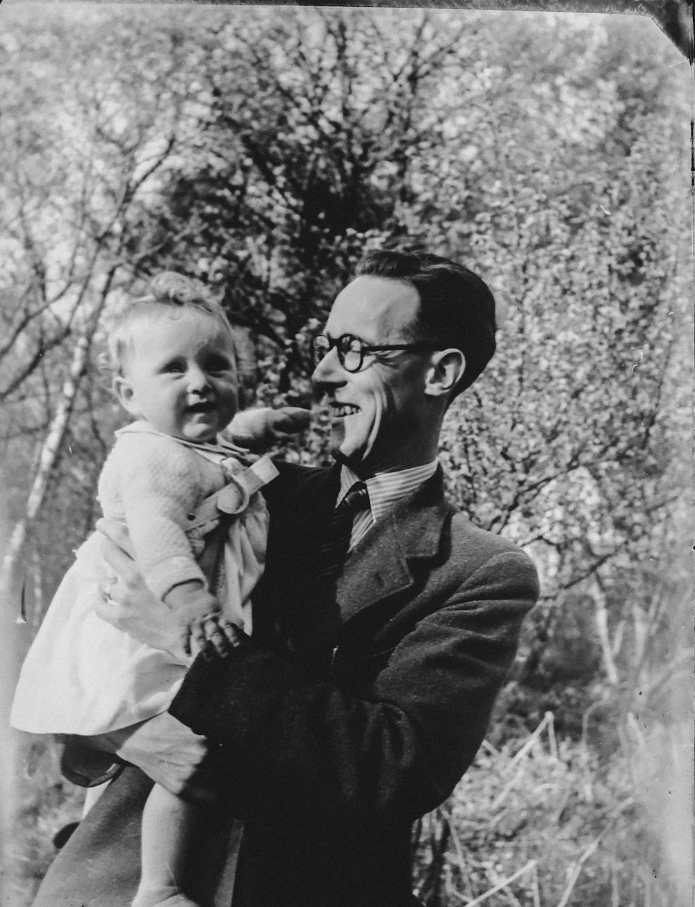 vintage photo of man holding a baby