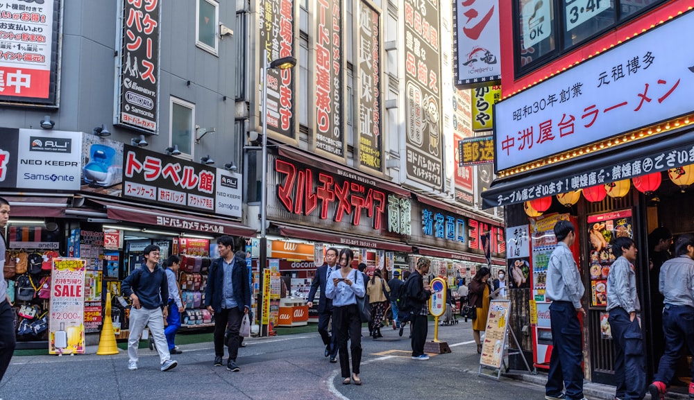 people walking on street surrounded by high rise buildings