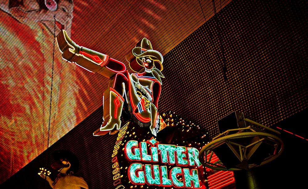 yellow and blue Glitter Gulch NEON signage