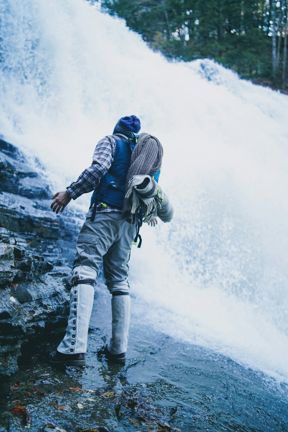 man standing on waterfall