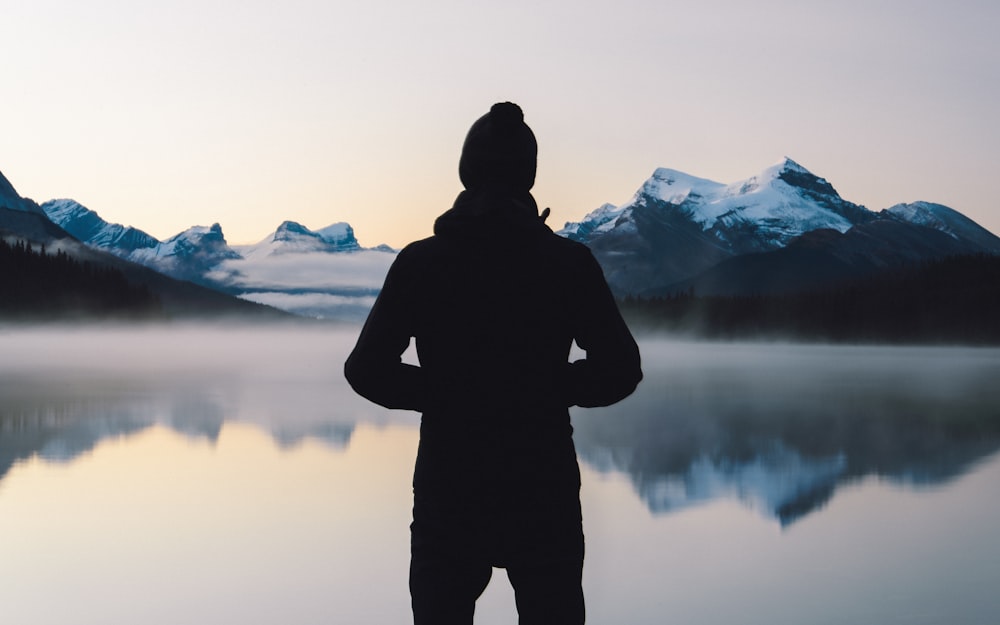 person standing in front of body of water outdoors