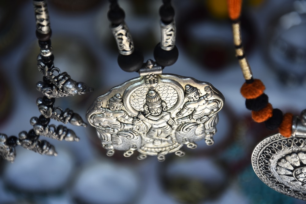 silver-colored pendant