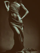 Silhouette of a woman’s body highlighting smooth contouring results in nude beige tones.
