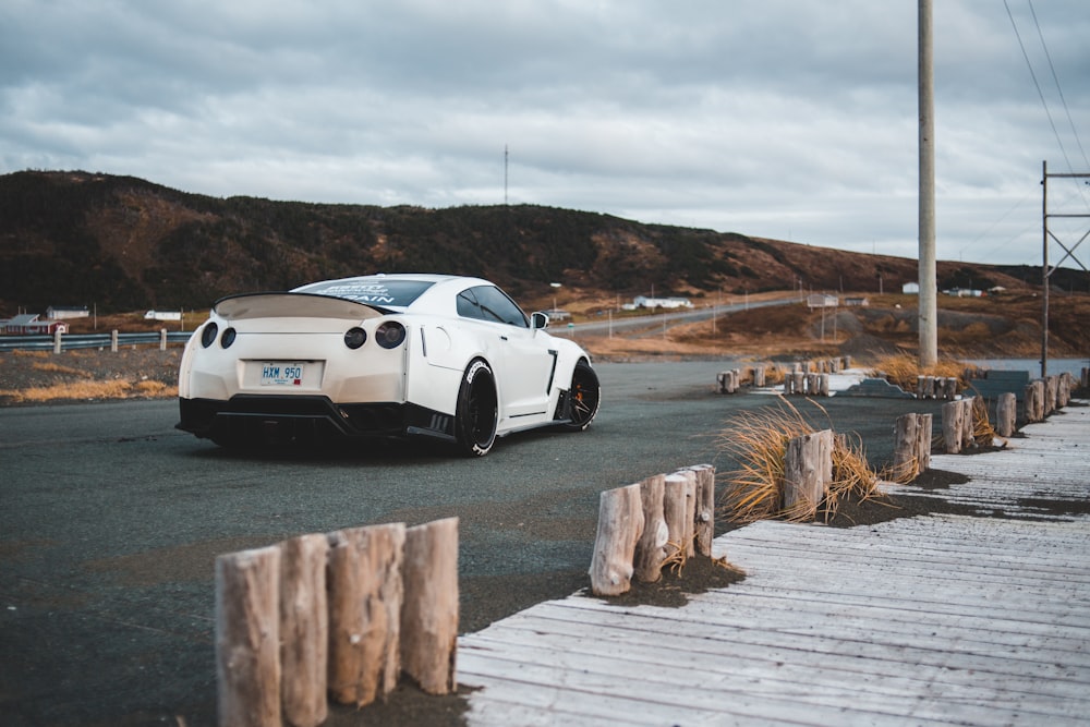 white sports coupe on road