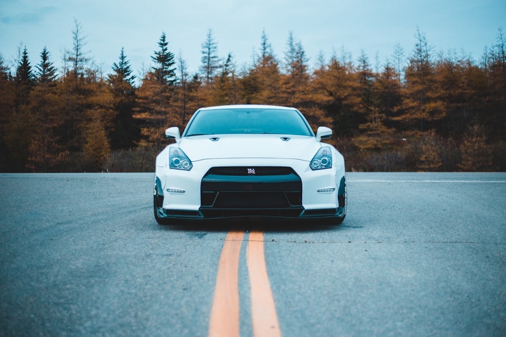 a white car parked on the side of a road