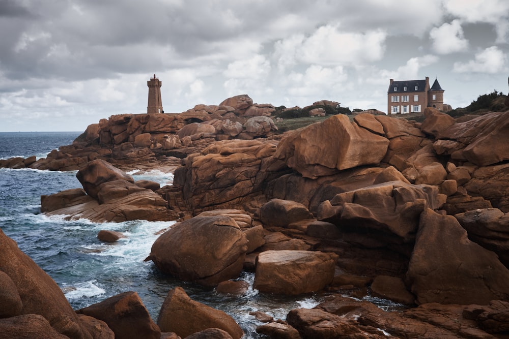 brown lighthouse on hill near shore