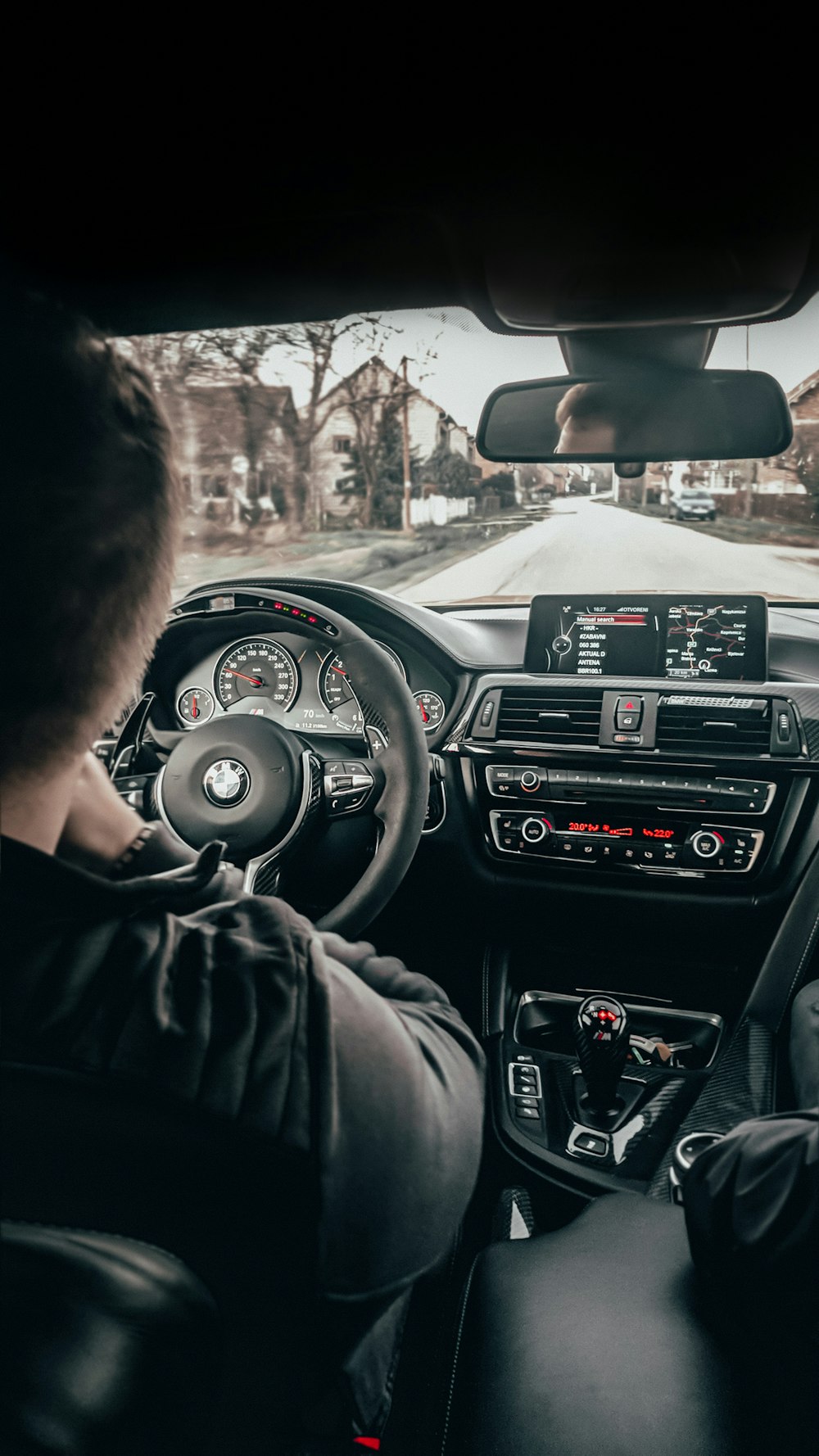 a man driving a car down a street