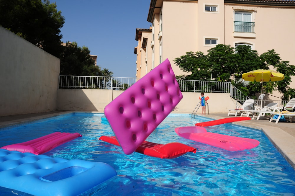 several pool floats on pool