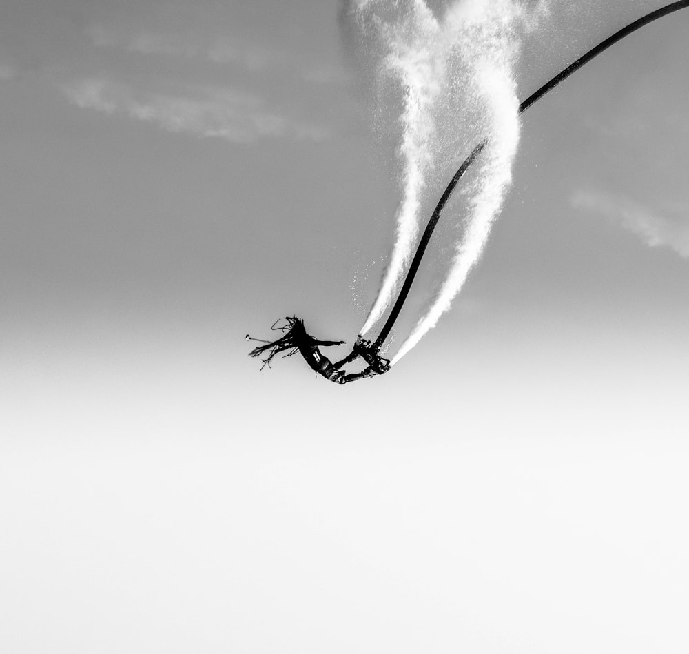 grayscale photography of person doing stunt on air