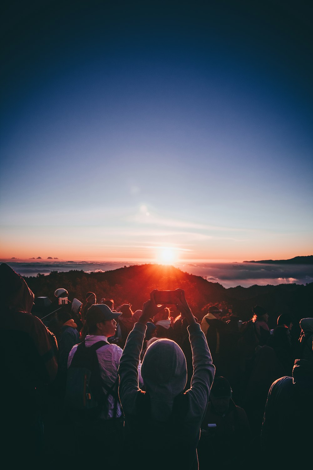 people standing on near mountains during golden hour