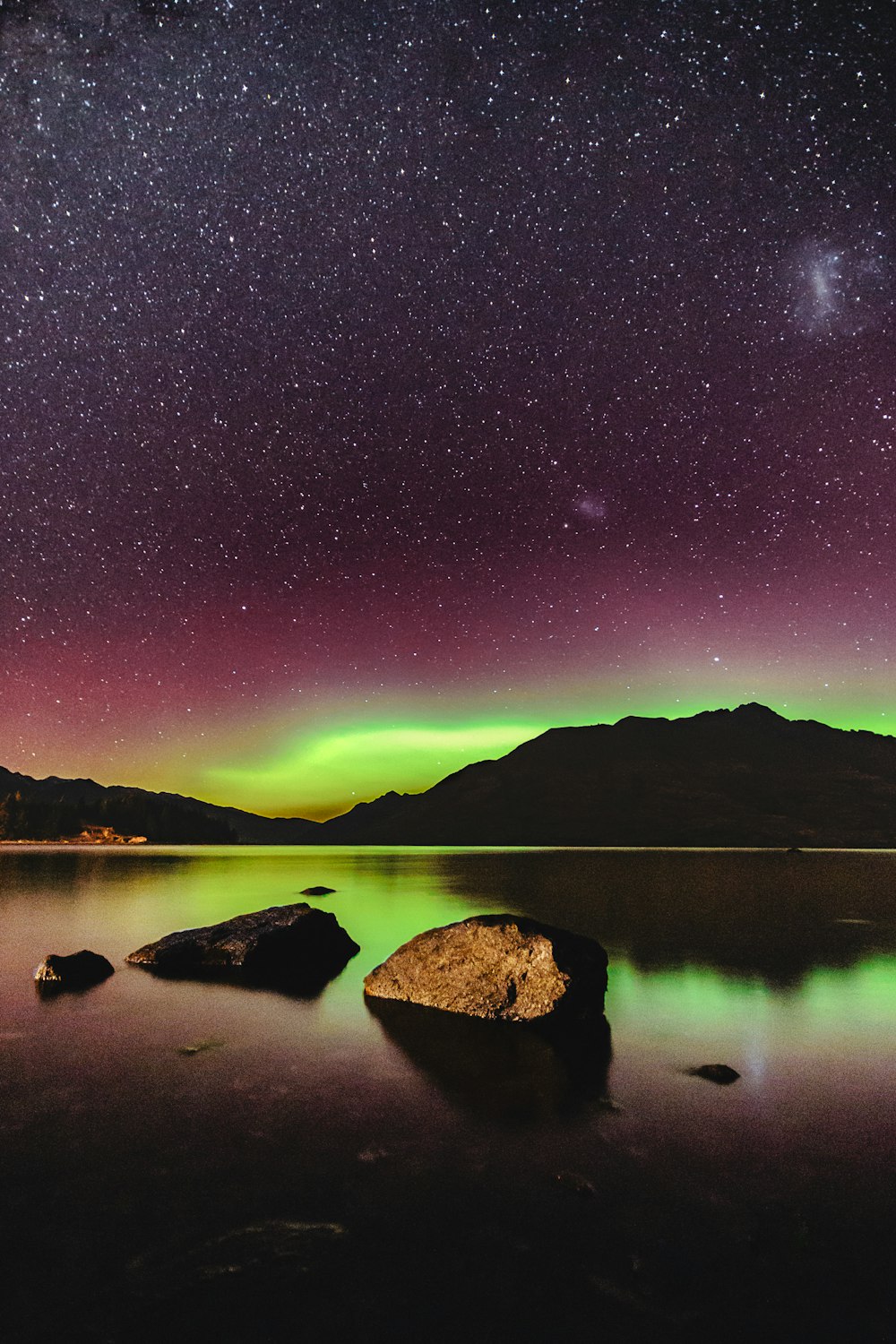 northern lights above body of water