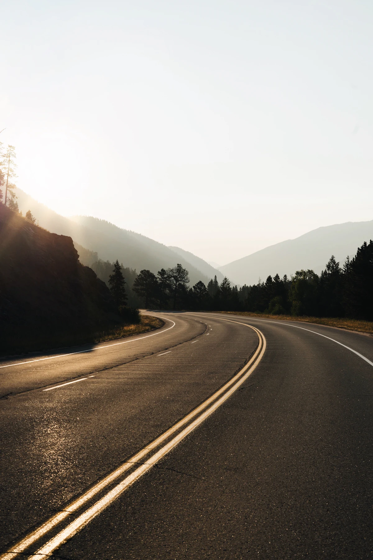 An empty road curving away between the hills