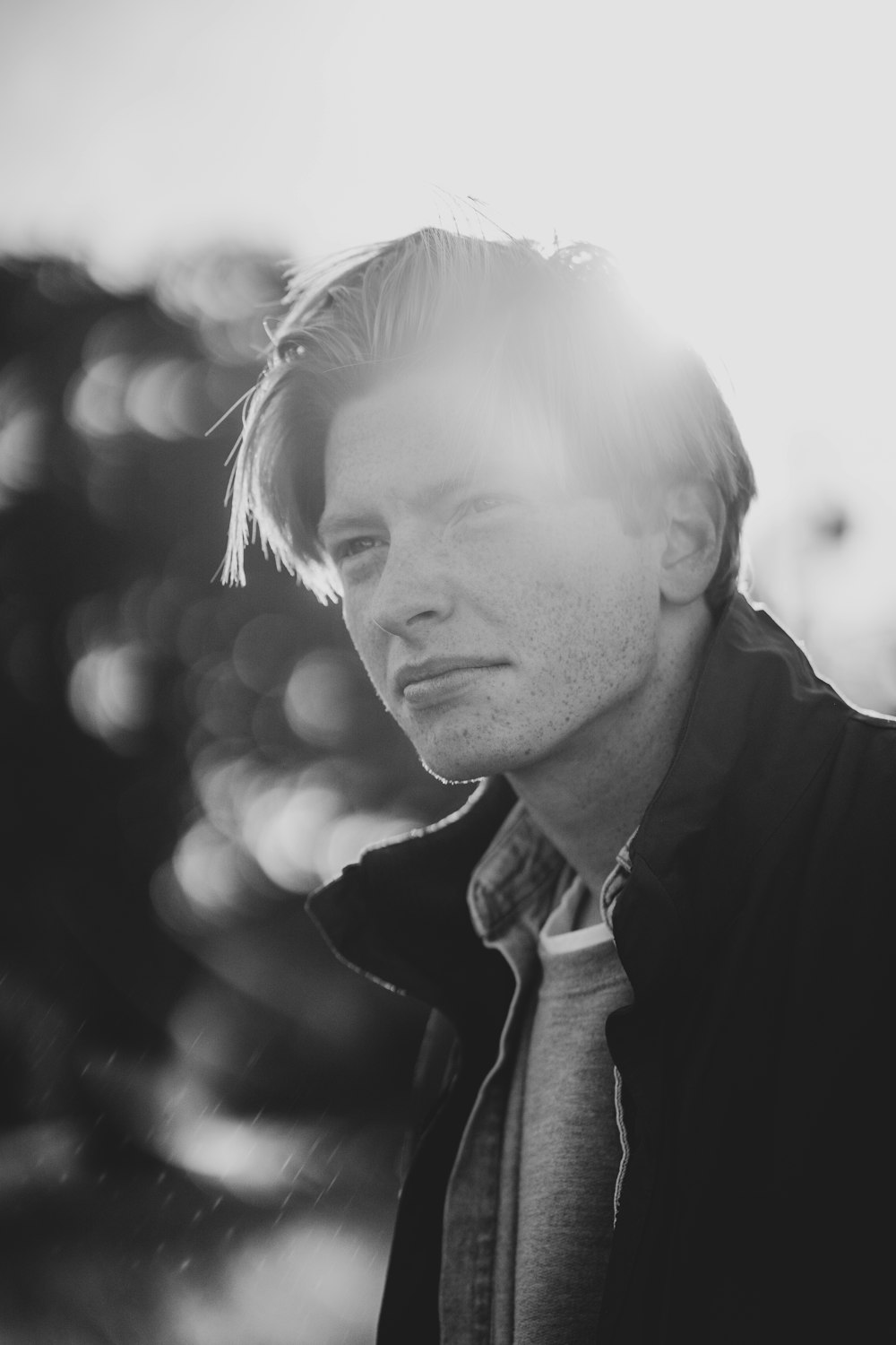 grayscale photo of man in jacket