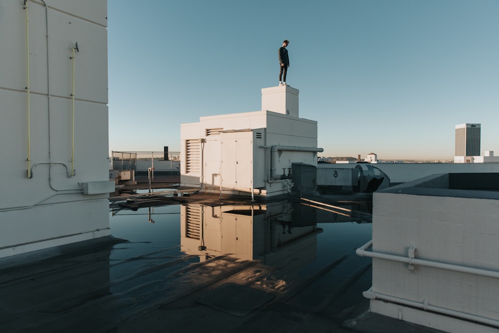 man stand on white building