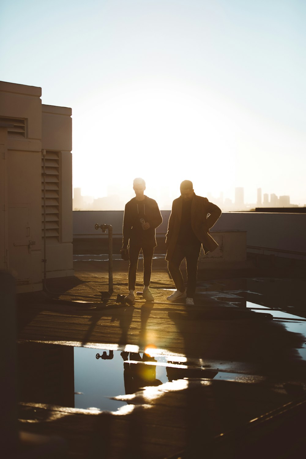 two men standing on rooftop