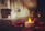 Close-up of a tflam candle glowing softly on a wooden table with natural decor.