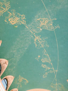 A wall decorated with zodiac signs and celestial artwork in soft pastel tones.