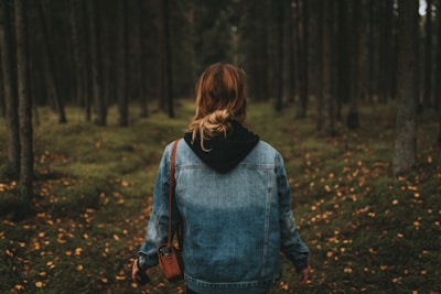 woman wearing blue denim jeans surrounded by trees