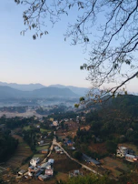 Close-up of natural landscapes around the village with rich green fields and traditional houses.