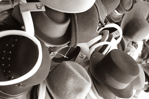 A mix of men's, women's, and unisex hats from different brands arranged neatly