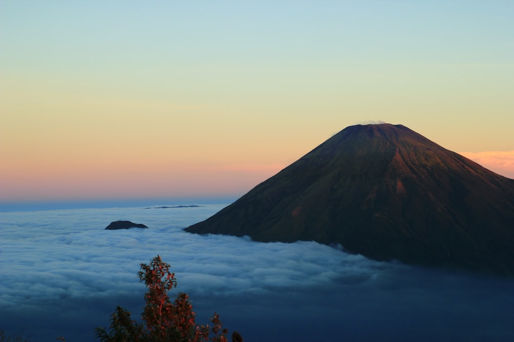 high-angle photography of volcano and clouds