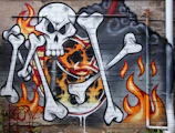 Finished spray artwork featuring bold black, red, and yellow colors with floating skull details.