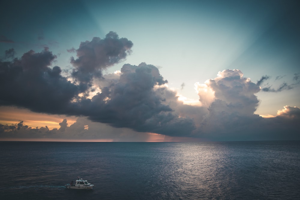 white boat on ocean during daytime