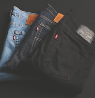 three assorted-color denim bottoms