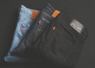 three assorted-color denim bottoms