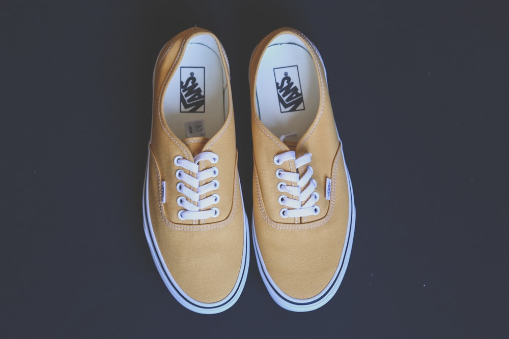 pair of yellow vans low-top shoes