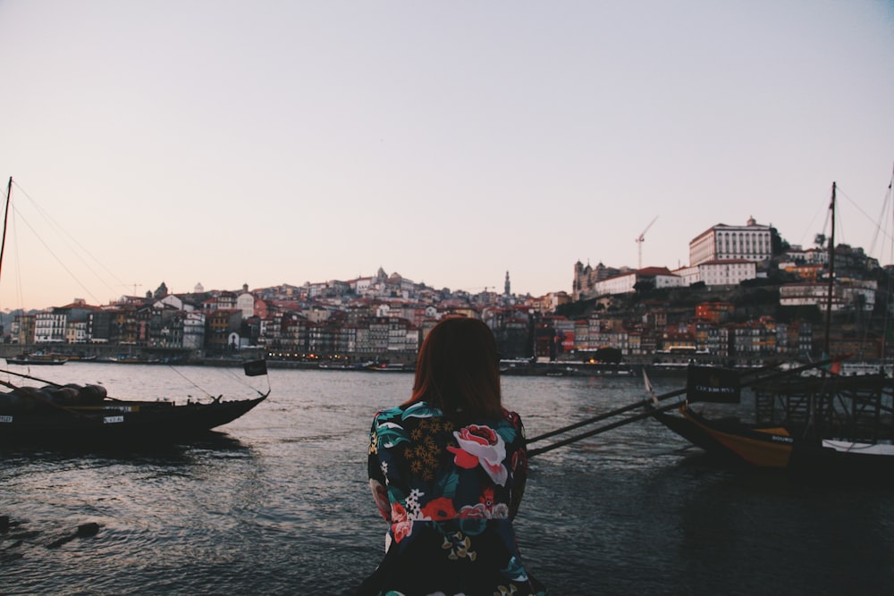 woman facing body of water