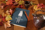 A person journaling with a cup of tea nearby, symbolizing daily mental wellness