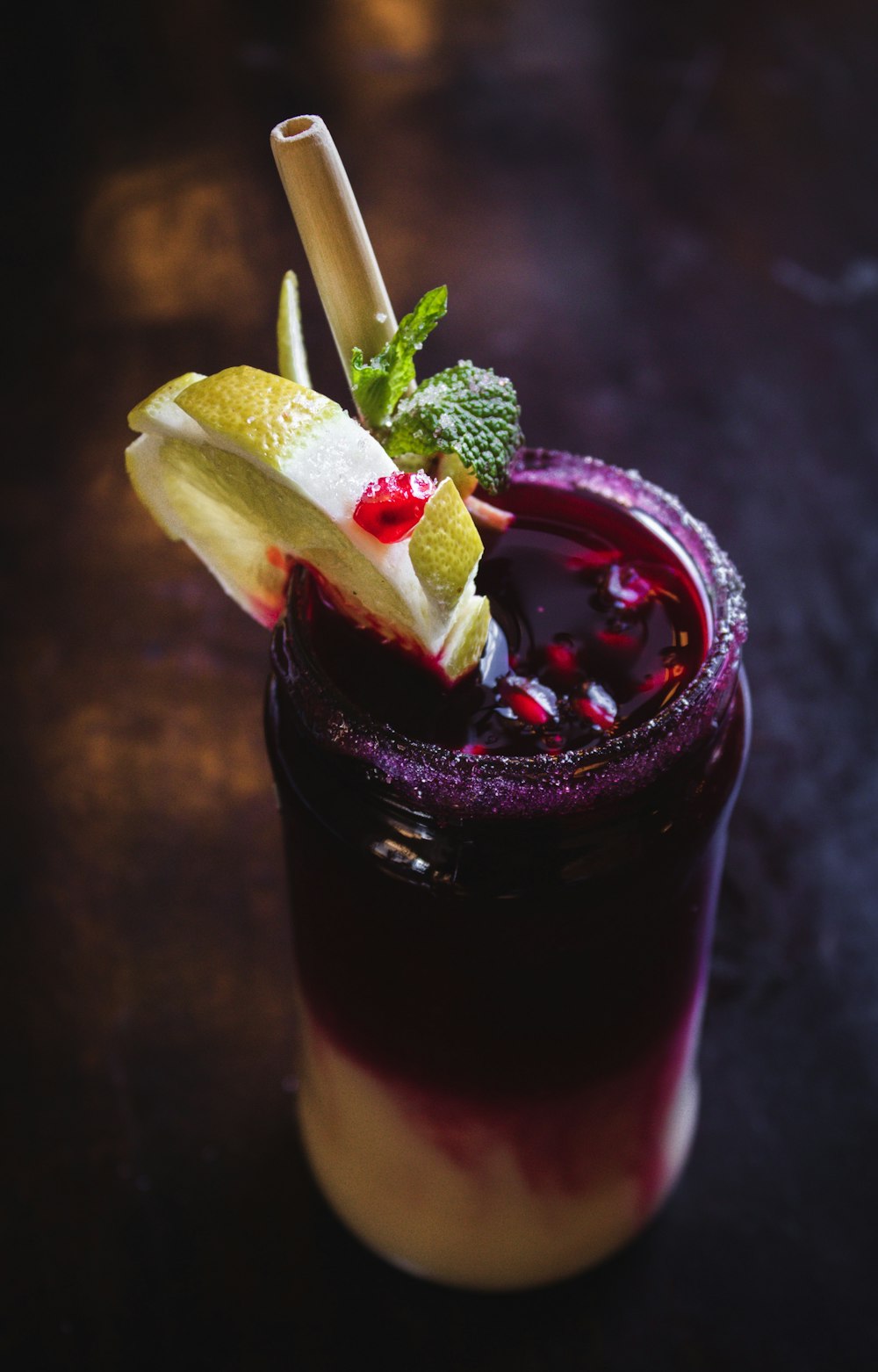 purple drink with straw and lemon slice