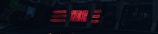 A series of neon signs are displayed on a building exterior, primarily featuring bold red lettering. The signs include text and geometric shapes, illuminated against a dark background, suggesting a nighttime urban setting.