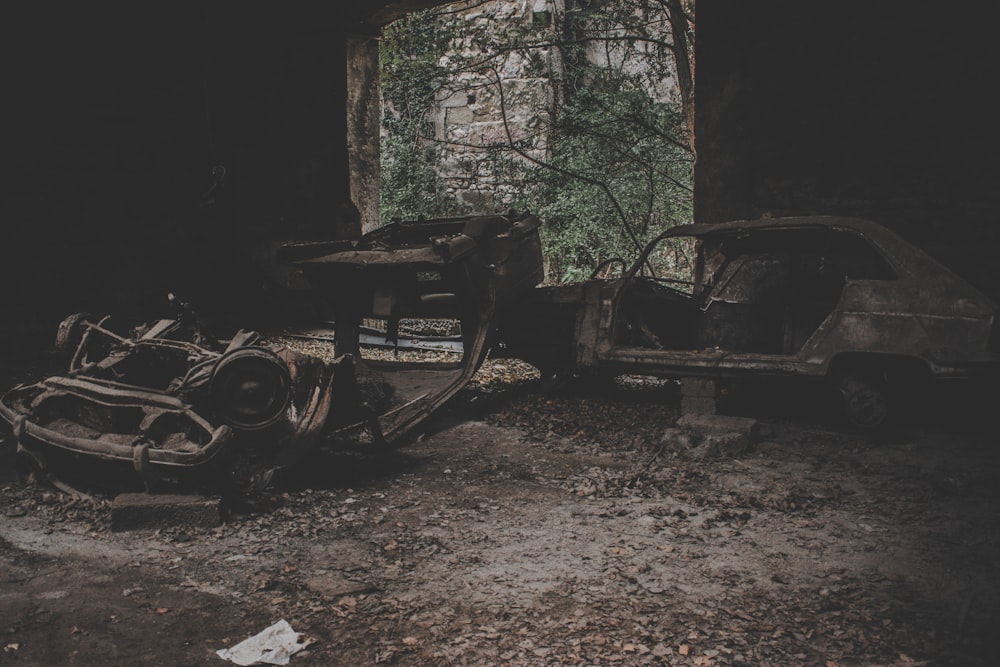 two gray wrecked vehicles inside room