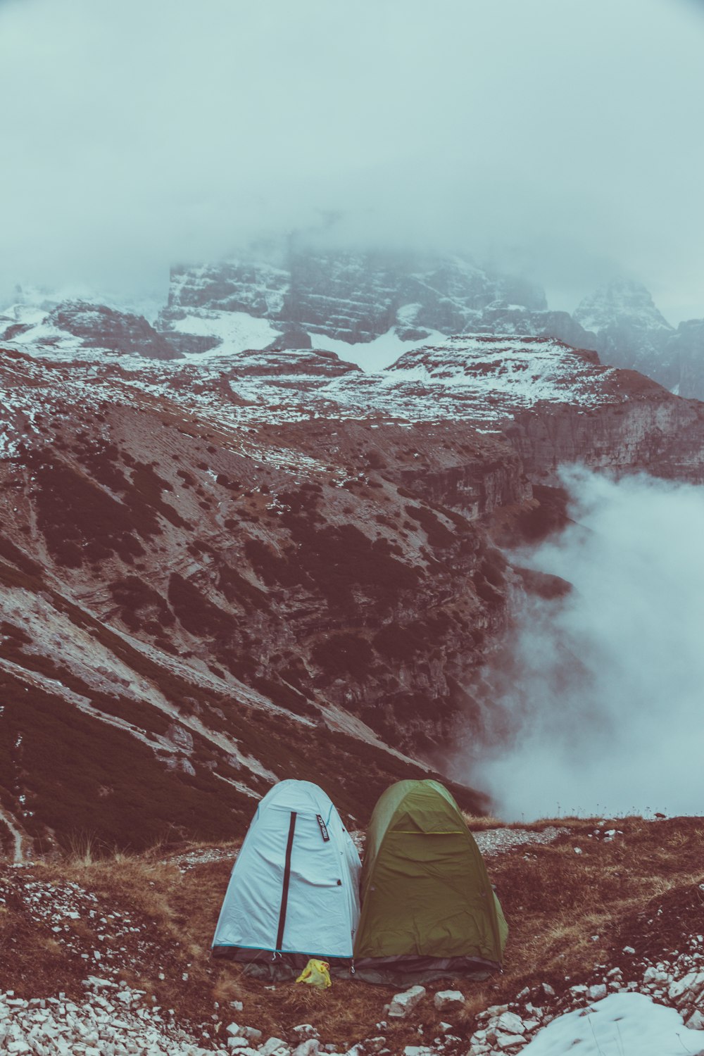 two tents near mountain covered with snow