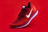 unpaired red Nike sneaker