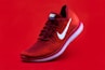 unpaired red Nike sneaker