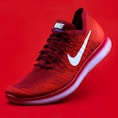 unpaired red Nike sneaker