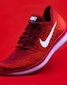 unpaired red Nike sneaker