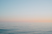 A serene ocean horizon at sunset, symbolizing the vastness of history and imagination.