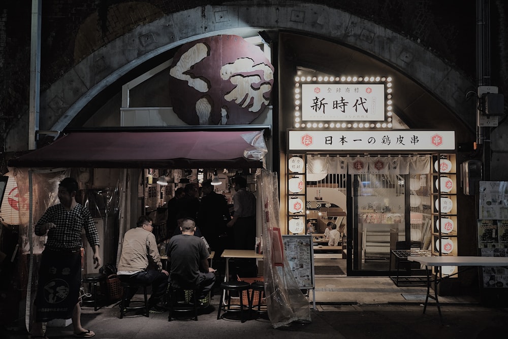 two men sitting in front of table