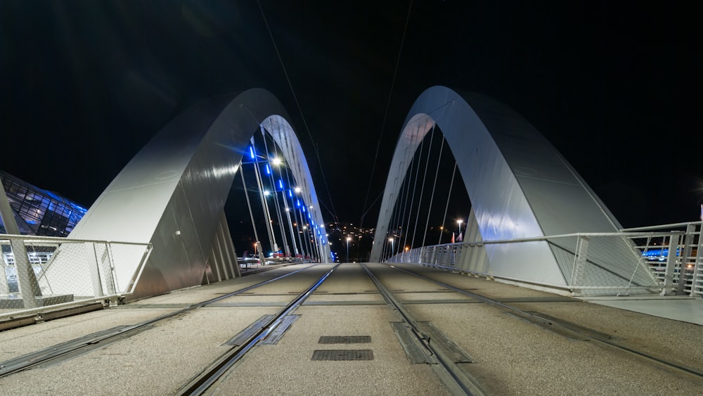 lighted concrete bridge during nighttime