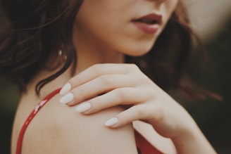 close-up of woman in red spaghetti strap top