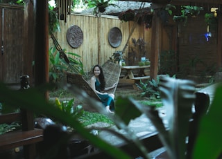 woman sitting on hammock on focus photography