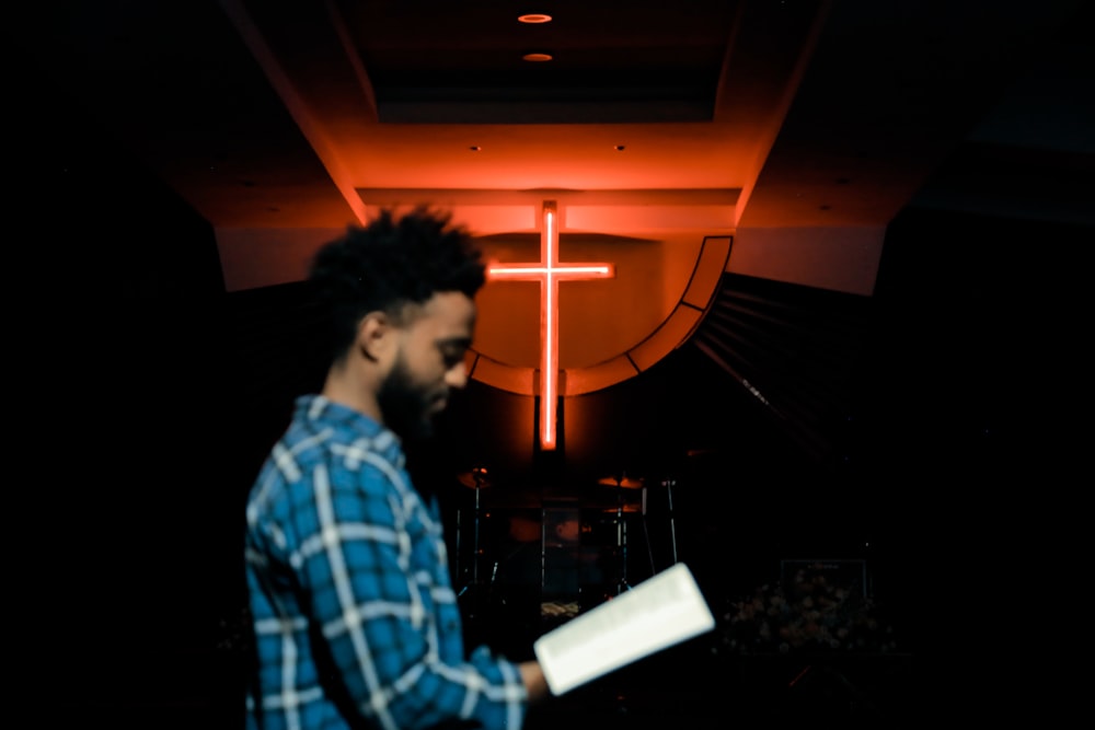 man holding white book