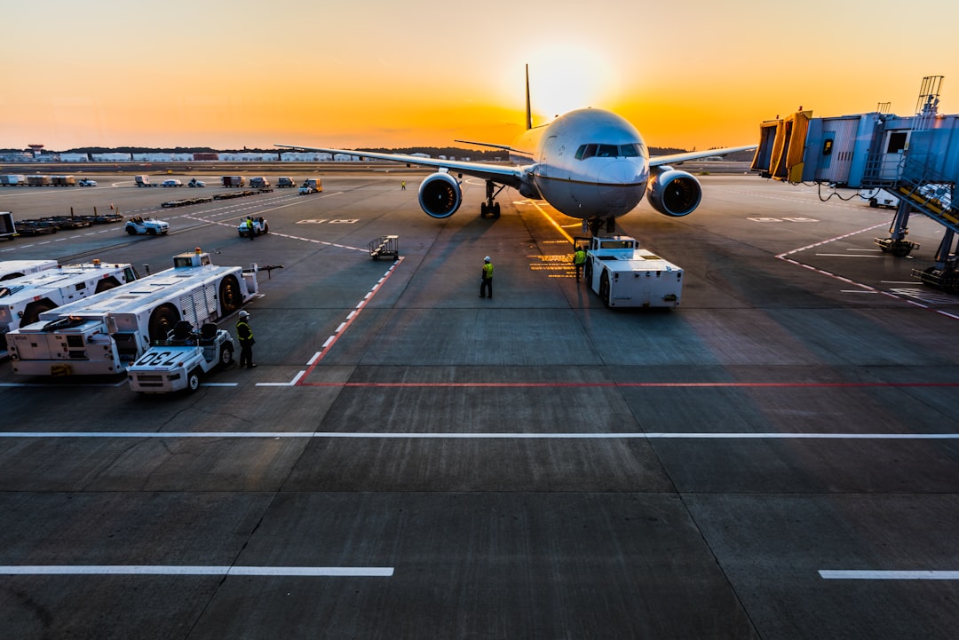 gray airplane on parking,