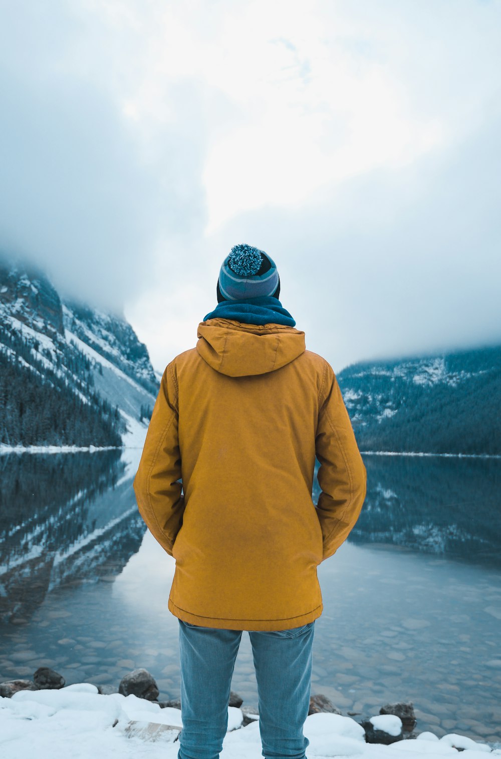 person standing on snow-covered cliff