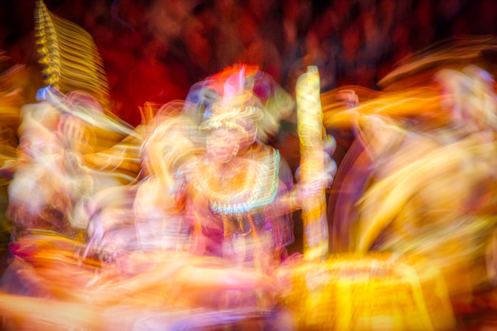 a blurry photo of people dancing in a carnival
